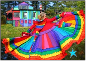 A woman spinning in a colourful dress in front of a multi-coloured house referencing frequency and energy
